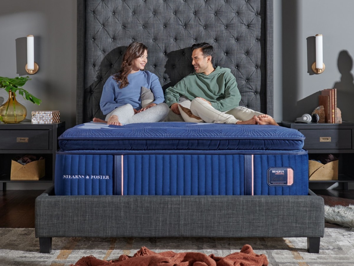 Couple in Stearns and Foster bed. Mattress size guide blog.